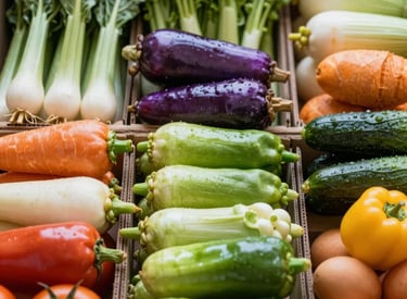 Close-up of a neatly packed box filled with vibrant fresh vegetables and fruits ready for delivery.