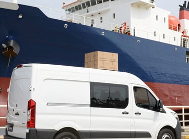 A sleek delivery van parked outside a modern office building with food packages ready.