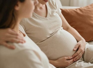 Photo of a doula taking notes while mentoring a small group in a cozy, sunlit room