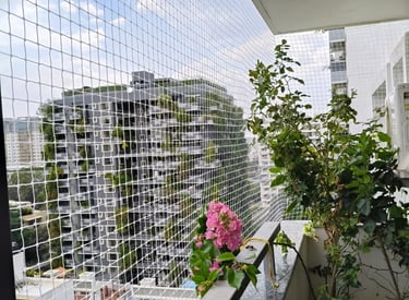Close-up of sturdy pigeon safety netting installed on a residential balcony in Guindy.