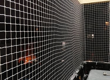 Close-up of a sturdy pigeon net securely installed on a Chennai balcony.