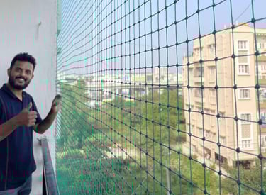 happy customer with a happy smile by the pigeon net installation in juhu mumbai