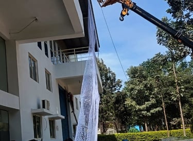 Industrial pigeon netting tightly covering a factory exterior.