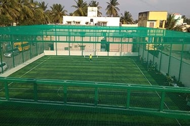 Wide shot of a rooftop sports area protected by a durable terrace sports net.