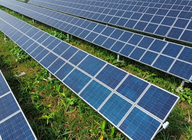 aerial photography of grass field with teal blue solar panels