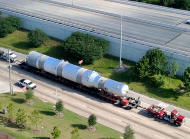 Heavy hauler being escorted by crews