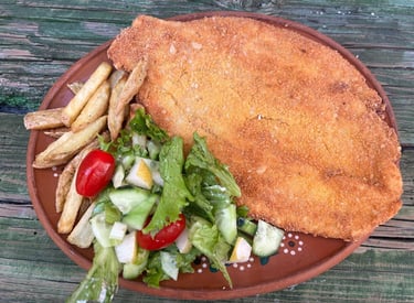 a plate of food with a chicken cut in half