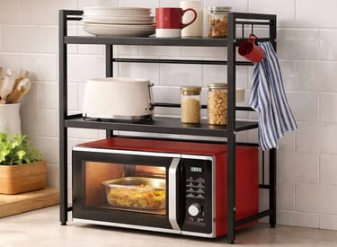 Kitchen countertop organizer shelving holding a microwave toaster dishes and pantry items