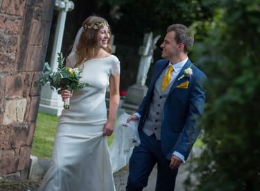 bride and groom walking around church grounds