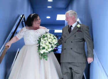 wedding couple walking down stairs