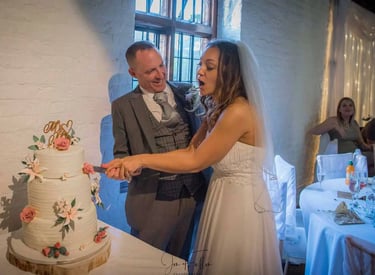 Wedding couple cutting their cake in Tudor Barn Eltham
