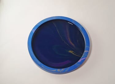 Handmade round dark blue tray with a dark galaxy swirl and northern lights pattern.