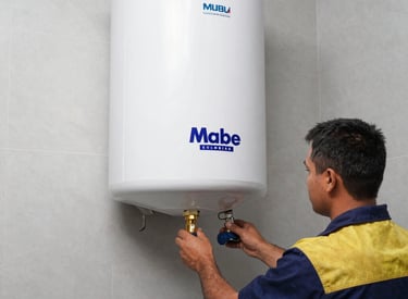 Technician inspecting a Mabe gas appliance inside a cozy Bogotá home.