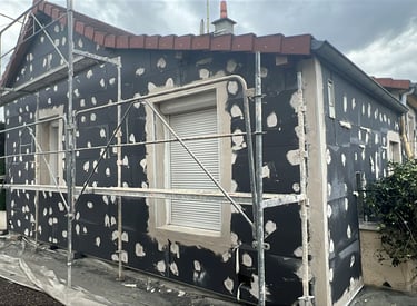 a house with a black and white polka doting on the side of the house