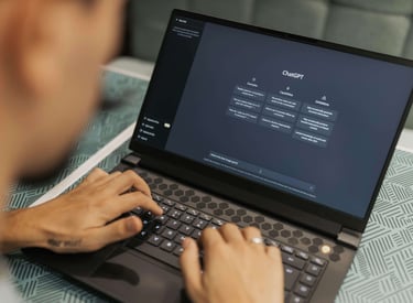 a person is using ChatGPT on a laptop computer