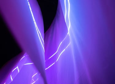 a person holding a knife and knife in front of a purple light