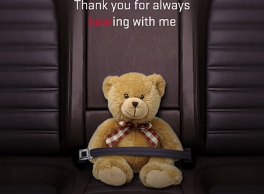 Teddy bear buckled into a leather Dodge car seat for a Happy Mother's Day message.