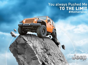 Jeep Wrangler climbing a steep rocky cliff under a dramatic sky with Mother's Day message 'You alway