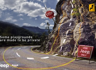 Jeep advertising campaign showing a winding mountain road blending into a rocky cliff with road mark