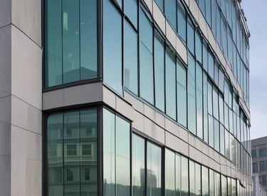 A skilled installer fitting a sleek glass storefront on a modern commercial building.
