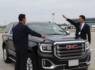 A spacious Chevrolet Suburban driving on the highway between Mecca and Medina under a clear sky.