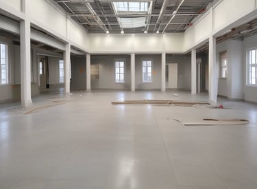 Construction site of a multi-story building with cranes and workers.