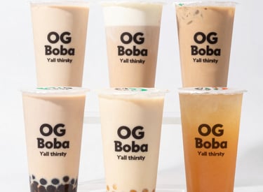 A vibrant cup of OG Boba with colorful tapioca pearls and fresh tea, set against a warm, inviting background.