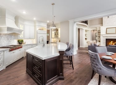 Newly built kitchen featuring custom cabinetry, countertops, flooring, and lighting