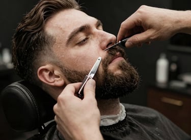 Barber shaping a client's beard carefully in a sleek, urban home environment.