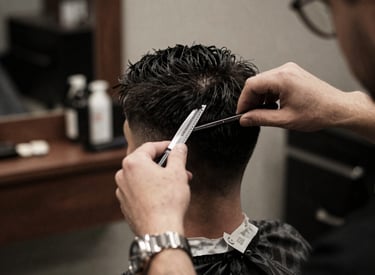 A stylish barber cutting a man's hair in a cozy home setting with modern decor.