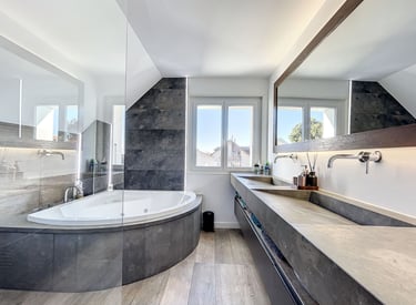 natural bathroom design with stone finishes, built-in bathtub and warm wood elements