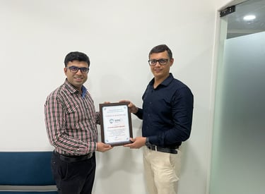 dr piyush vasaikar dhul presenting a certificate of clinical fellowship in a medical office setting.