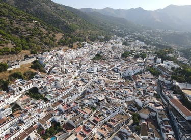 Aerial view of Mijas Pueblo with white houses and mountain landscape in Sierra de Mijas, Spain