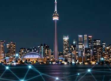 A glowing digital network graphic overlaying a futuristic city skyline at night.