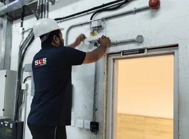 a man in a white helmet installing electrical systems