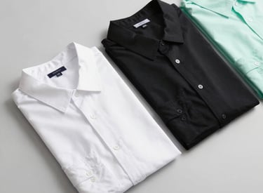 Stacks of neatly folded premium men's shirts ready for shipment in a clean warehouse.