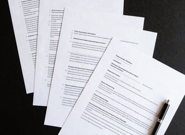 Human Resources application forms and black pens on a desk for hiring and recruitment.