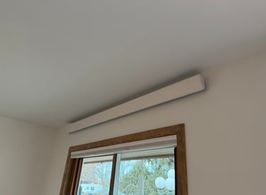 indoor overhead heater above a wooden framed window