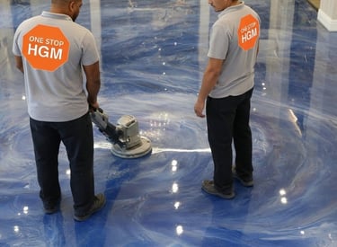 two men in white shirts and blue jeans standing in a room buffing a finished epoxy floor