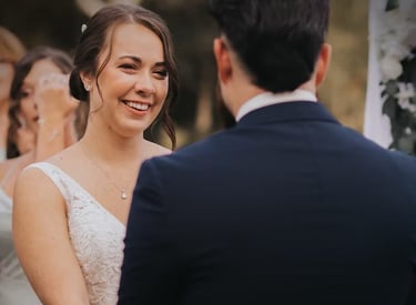 a bride and groom smiling at each other