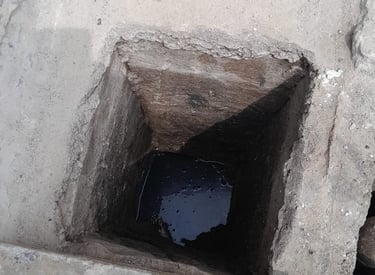 a person standing in a hole in a concrete wall