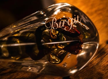 a glass bottle of wine with a message on it