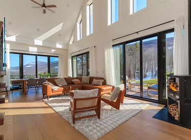 Embrace modern luxury amidst nature's serenity in this light-filled haven. Floor-to-ceiling windows