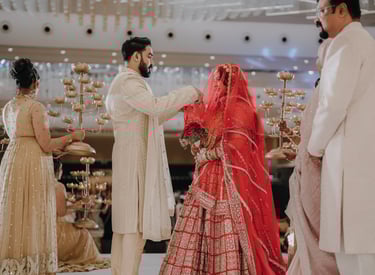 a man and woman in traditional indian wedding attire