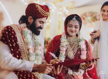 a man and woman in traditional indian wedding attire