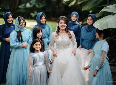 a woman in a white dress and a group of women in blue dresses