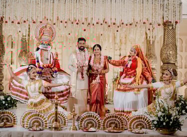 Traditional Kerala wedding ceremony featuring a bride, groom, and Kathakali dancers on a decorated stage.