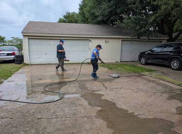 Team surface cleaning a residential driveway in Denton Texas.