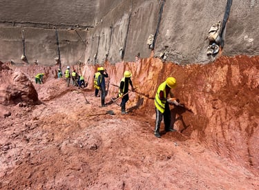 Hillside with soil nailing and geogrid reinforcement for slope stabilization.