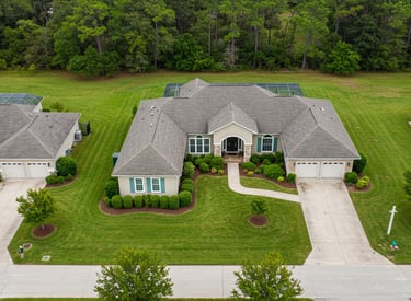 a large house with a tennis court and tennis court